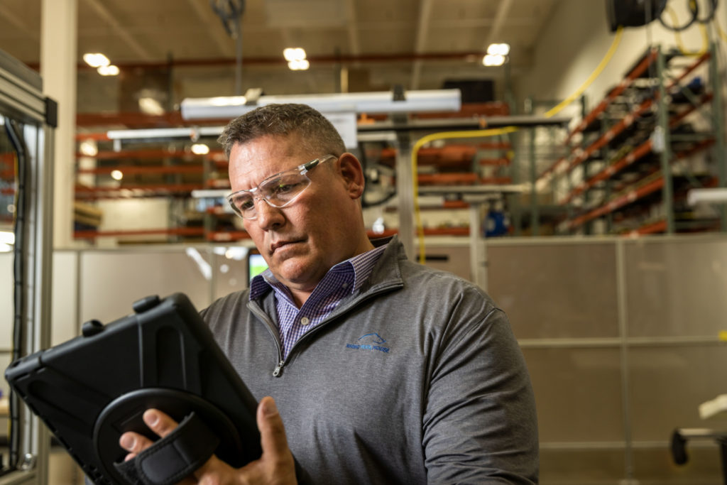 man on ipad with safety goggles | Rhino Innovation