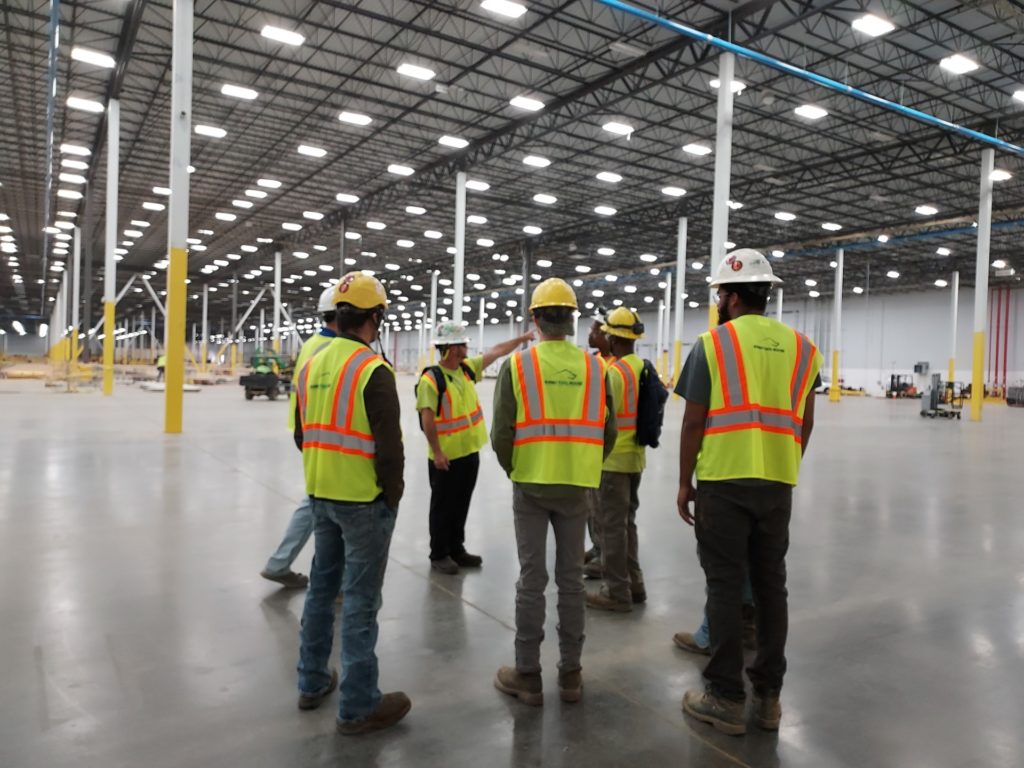 group of people standing with hardhats | Rhino Innovation