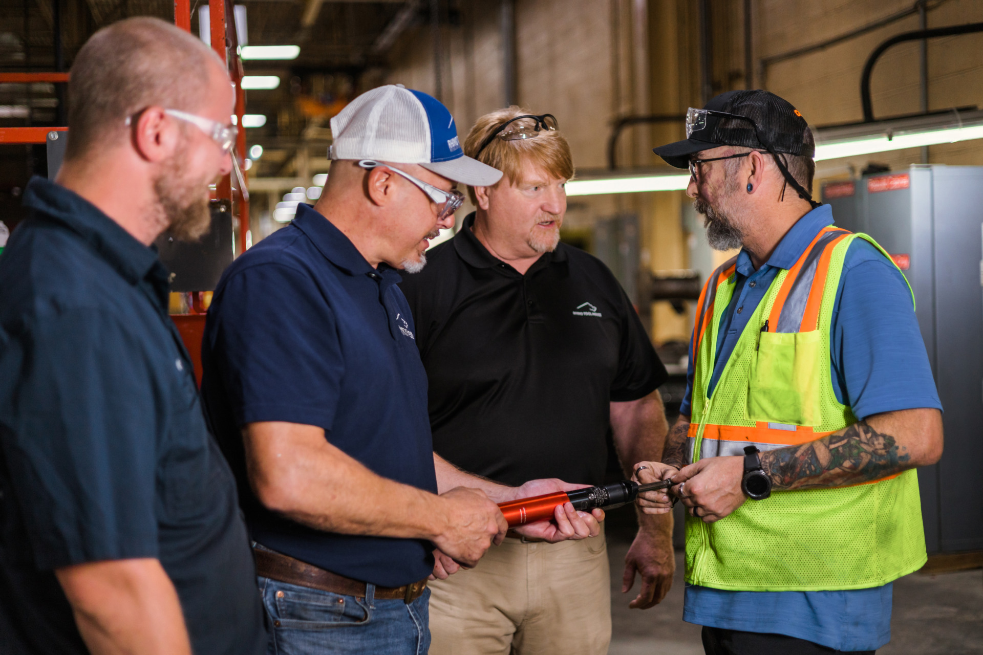 group of men standing in a warehouse talking | Rhino Innovation