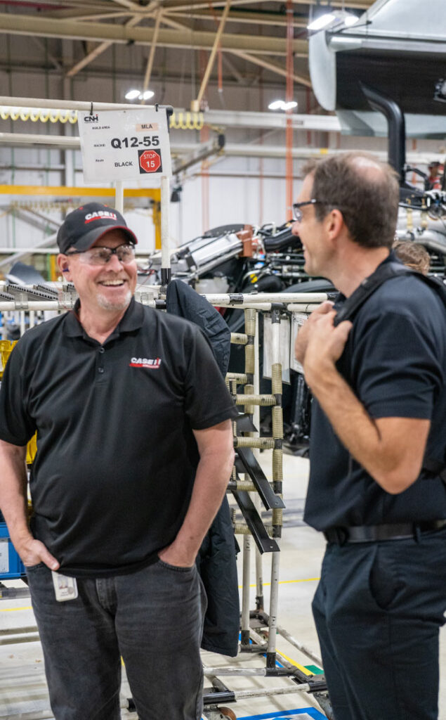 employees working together on heavy machine manufacturing